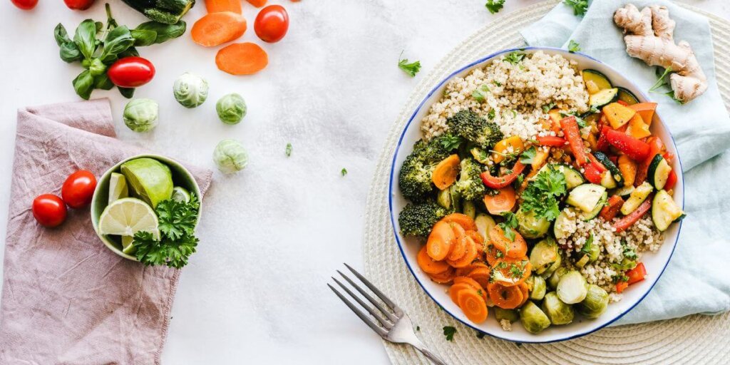 Healthy vegetarian lunch bowl on a table with a fork