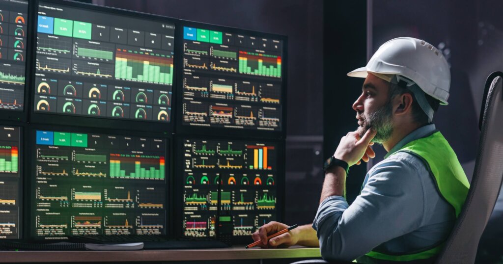 Construction worker in front of computer programs
