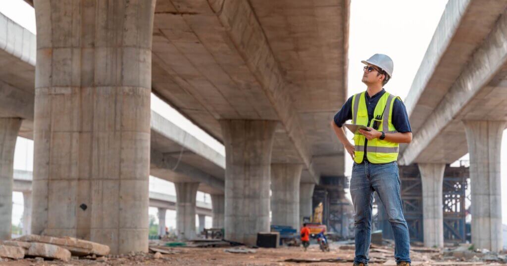 A civil engineer is inspecting a road or expressway construction project under a road under construction