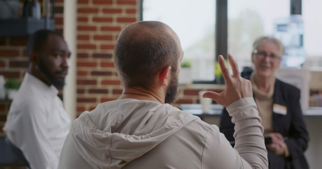 Close up of man complaining about mental health problems at a support group meeting.