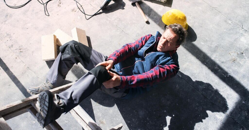 Construction worker that fell and is holding his knee
