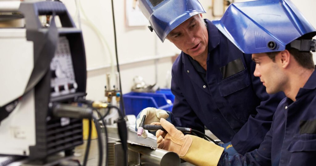 Engineer Teaching Welding Apprentice To Use TIG Welding Machine.