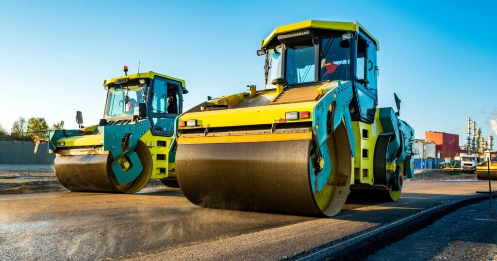 Large view on the road rollers working on the new road construction site.