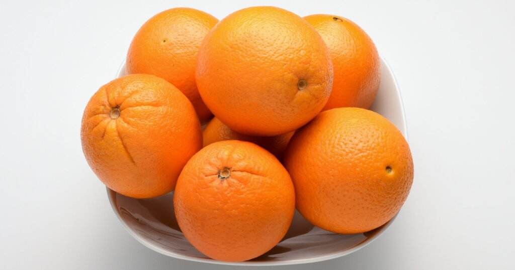 Oranges in a bowl on a table