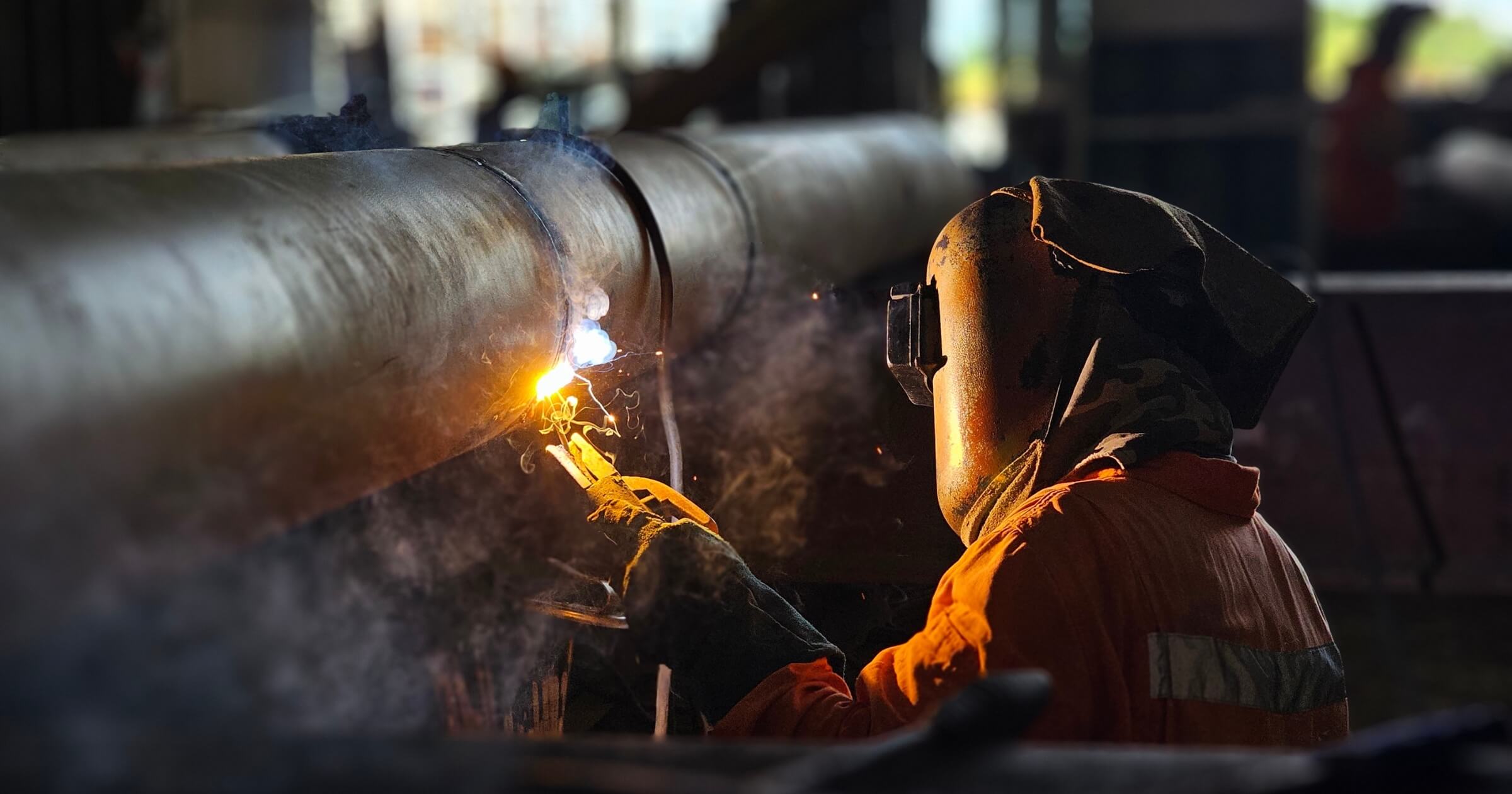 Professional welder doing welding activity for piping materials.