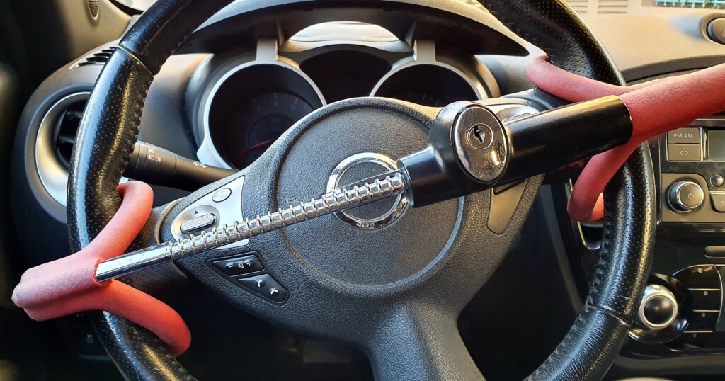 Anti-Theft Car Steering Wheel Lock Car Security. Black And Red Colors. Close Up View