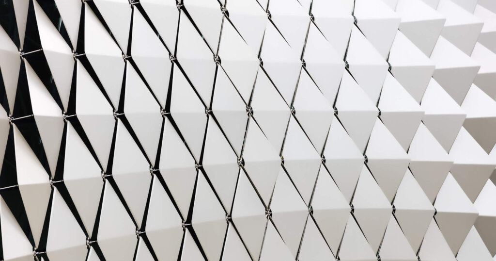 Abstract close-up view of modern aluminum ventilated triangles on facade.