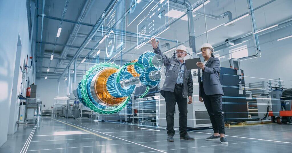 Factory Digitalization: Two Industrial Engineers Use Tablet Computer, Visualize 3D Model of Clean Green Energy Engine. Industry 4 High-Tech Electronics Facility with Machinery Manufacturing Products
