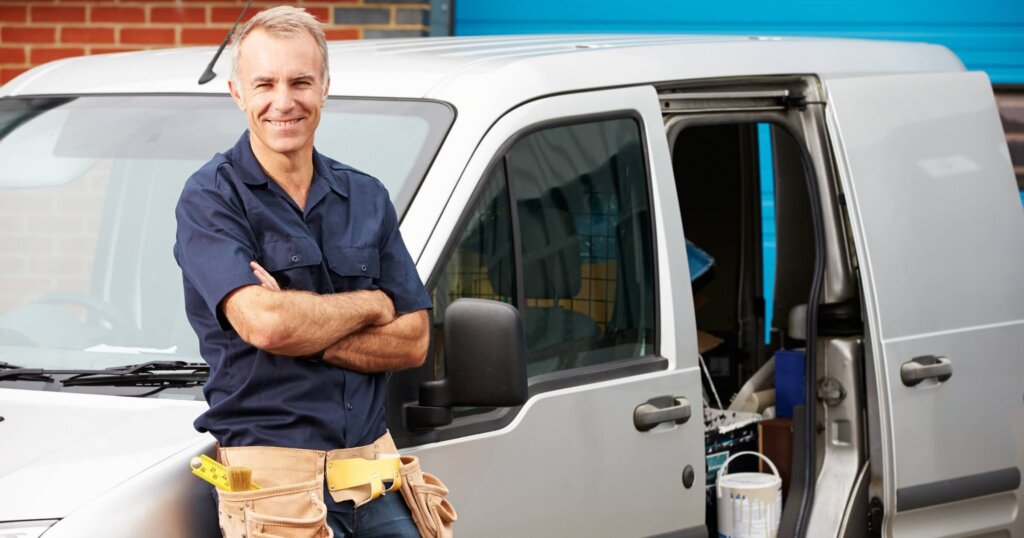 Plumber Standing Next To Van