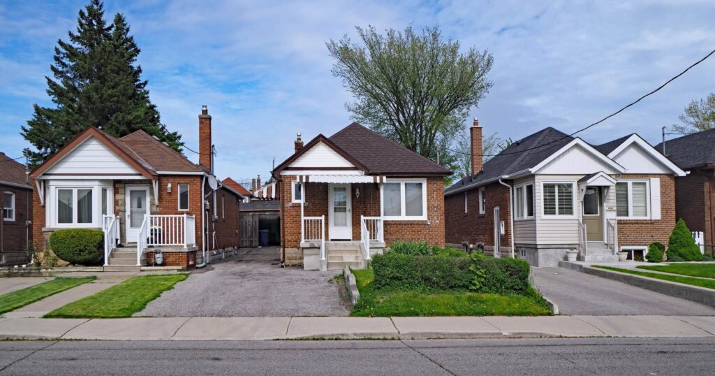street with old fashioned 1950s style working class bungalows