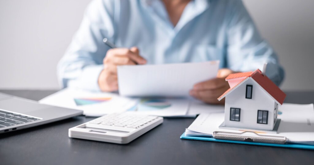 House with money. Concept of finance or refinance real estate. Symbol of house stands against background of us dollars. Property investment. Home mortgage loan rate. Saving money for retirement.