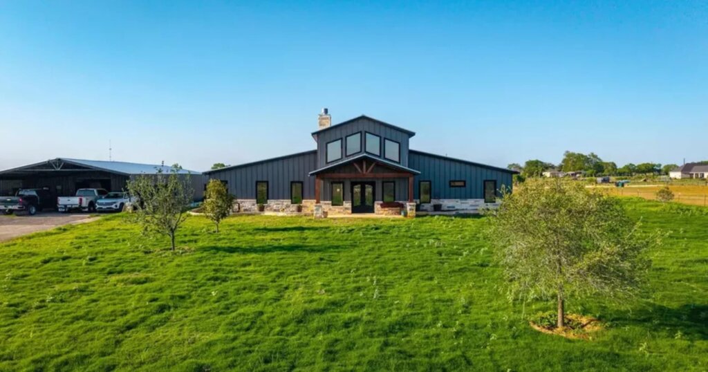 country barndominium exterior in a field. 