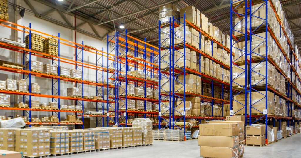 Interior of a modern warehouse storage of retail shop with pallet truck near shelves.