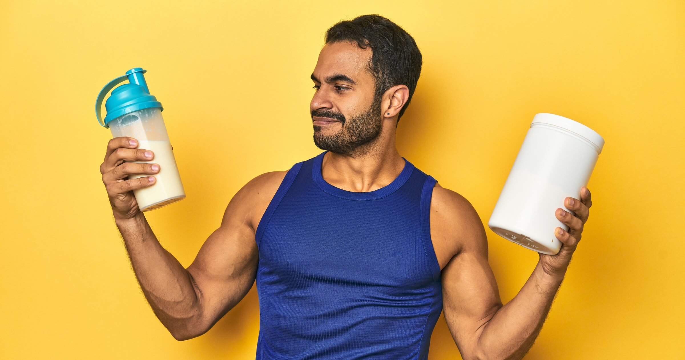 Fit Latino man with protein shake and supplement, supporting sports nutrition.