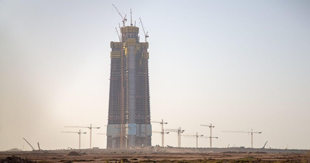 Jeddah tower under construction in a desert.