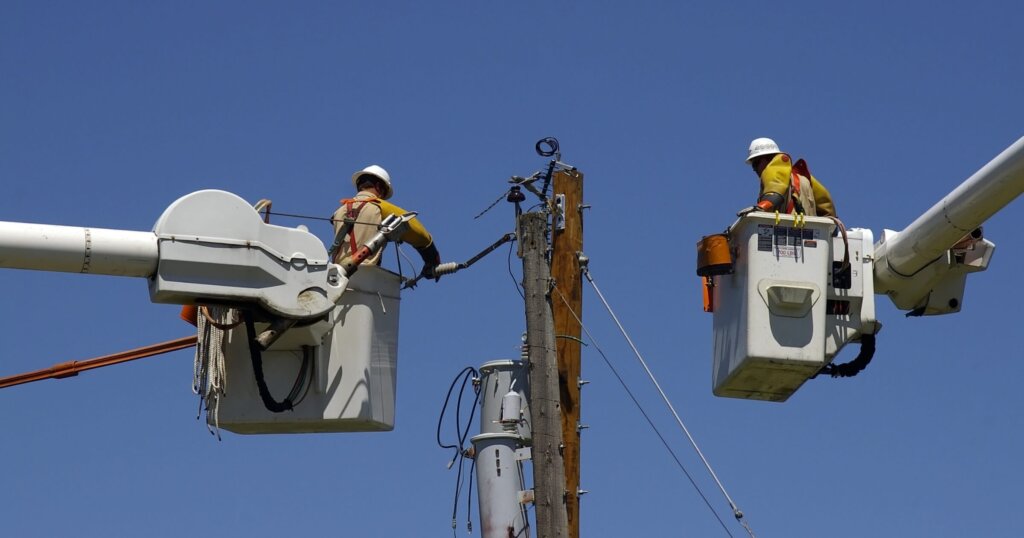 Linemen replacing old utility pole