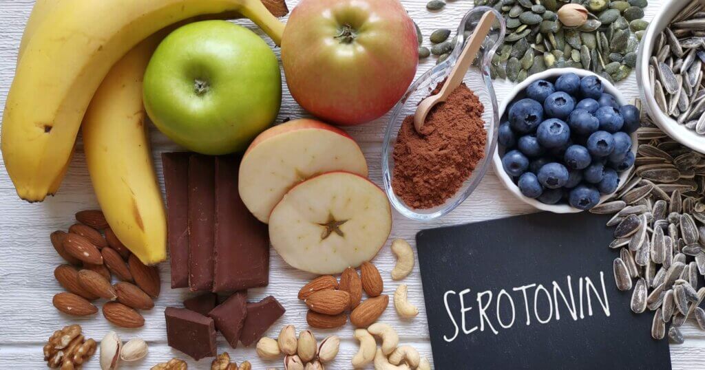 Serotonin-boosting foods. Assortment of food for good mood, happiness, better memory, and positive mind. Healthful foods that may help boost serotonin. Natural sources of serotonin, healthy diet.