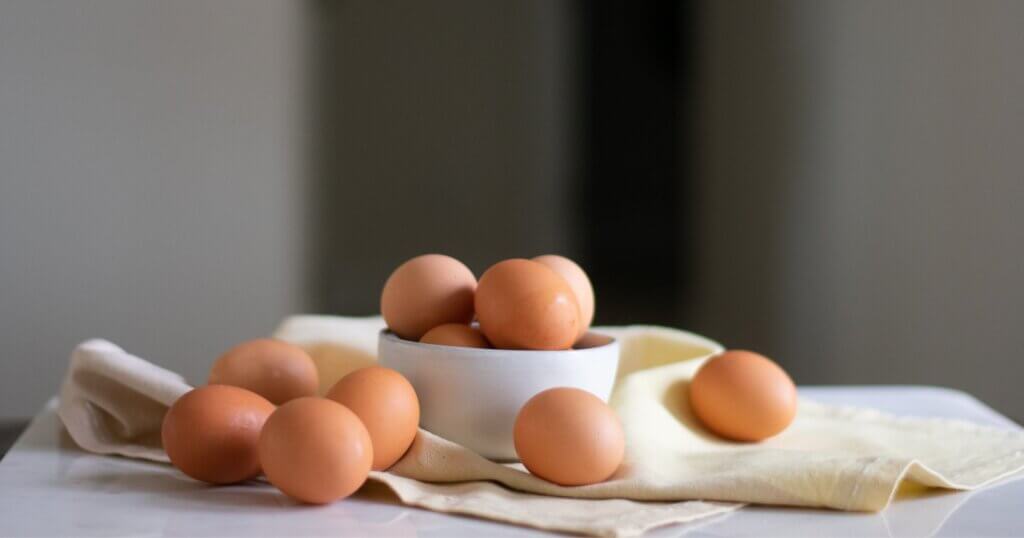 eggs in a bowl on a table.