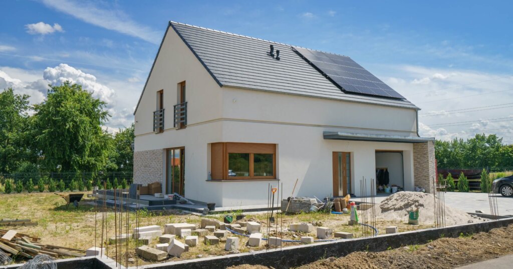 New build modern house with gable roof and solar panels.