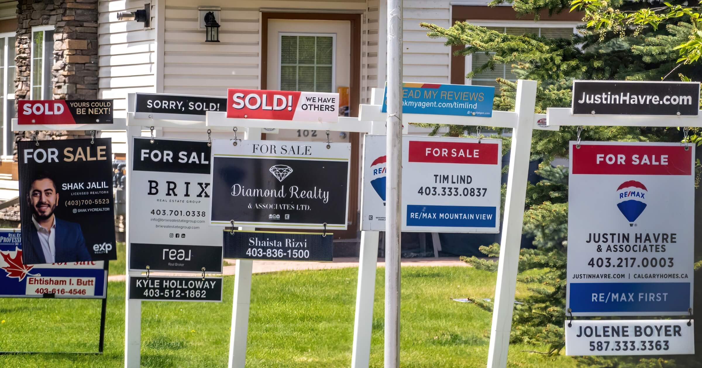 Calgary, Alberta, Canada. May 22, 2023. Several real estate signs during spring.