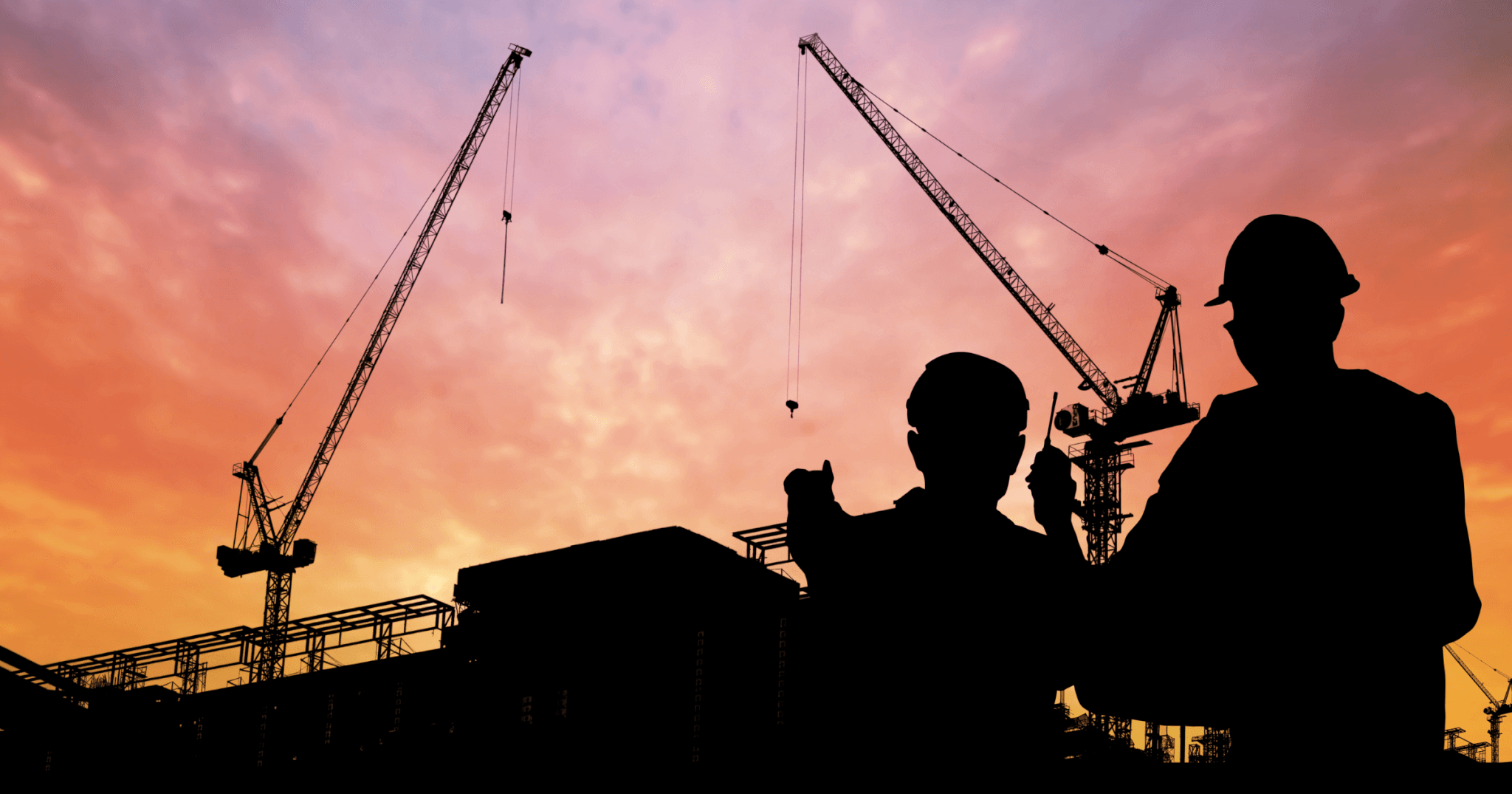 workers on a jobsite discussing construction challenges