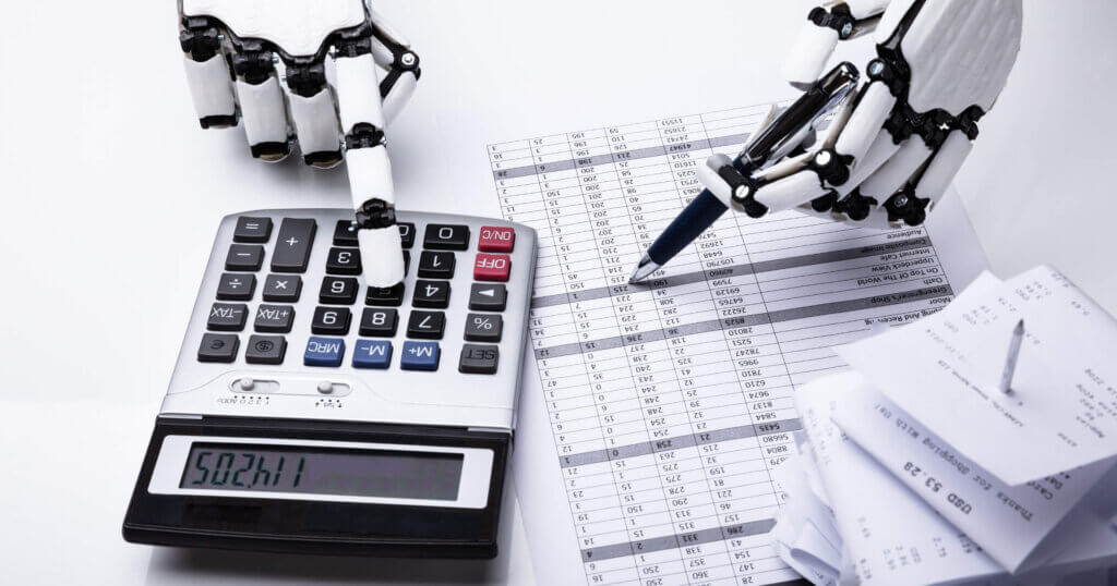Close-up Of Robot Examining Financial Report With Calculator On Desk