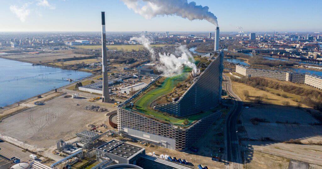 Copenhagen, Denmark - March 05, 2021: Aerial drone view of Amager Bakke, a waste to power plant with a ski slope on top.