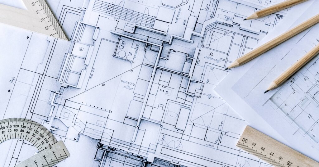 Architectural engineering design plan drawing on the table. Architect's work on table in studio. Construction design and plan