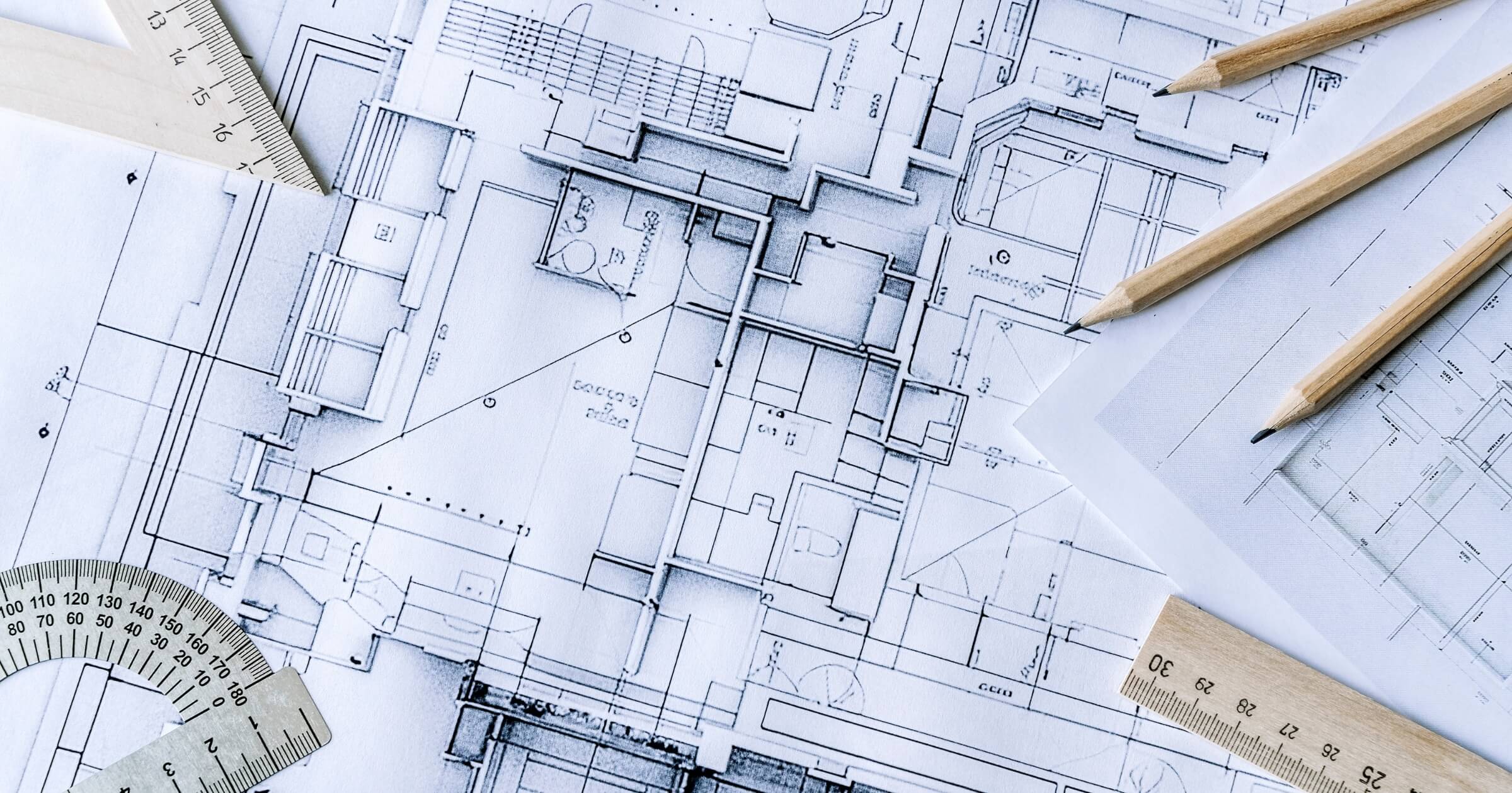 Architectural engineering design plan drawing on the table. Architect's work on table in studio. Construction design and plan