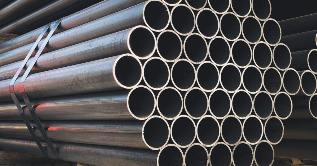 black steel pipes on shelf in stock yard of factory.Black steel pipe, construction industry