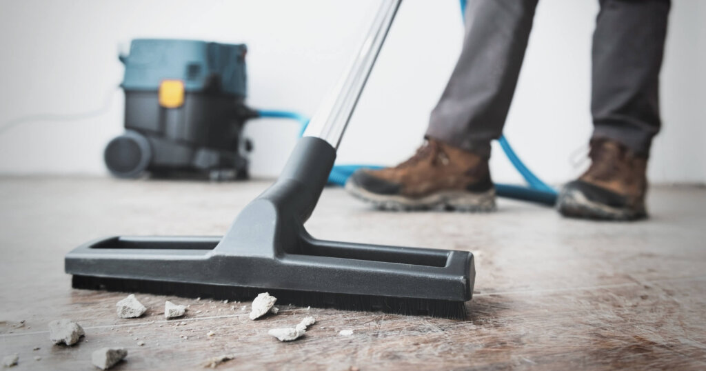 Professional construction cleaning service with powerful vacuum cleaner.