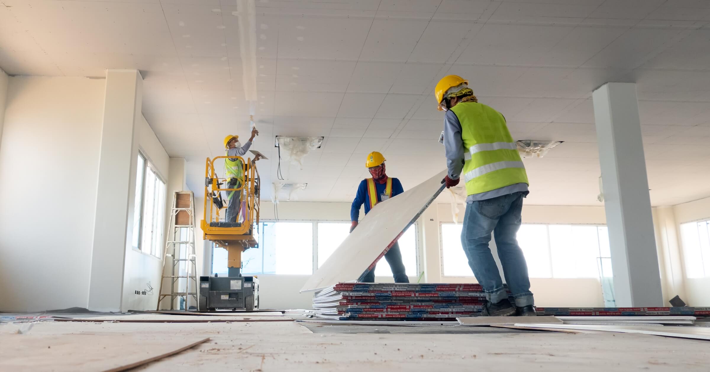 Construction worker installation ceiling work and drywall