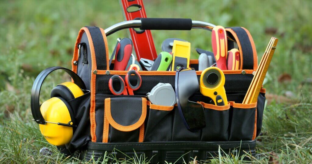 tool bag with different tools for repair on grass outdoors