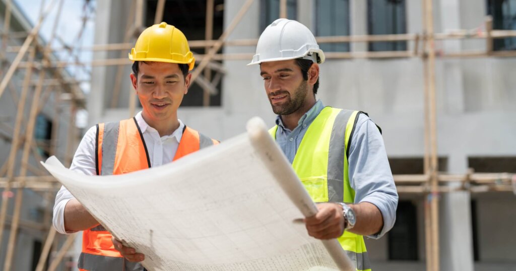 civil engineers look at blueprints