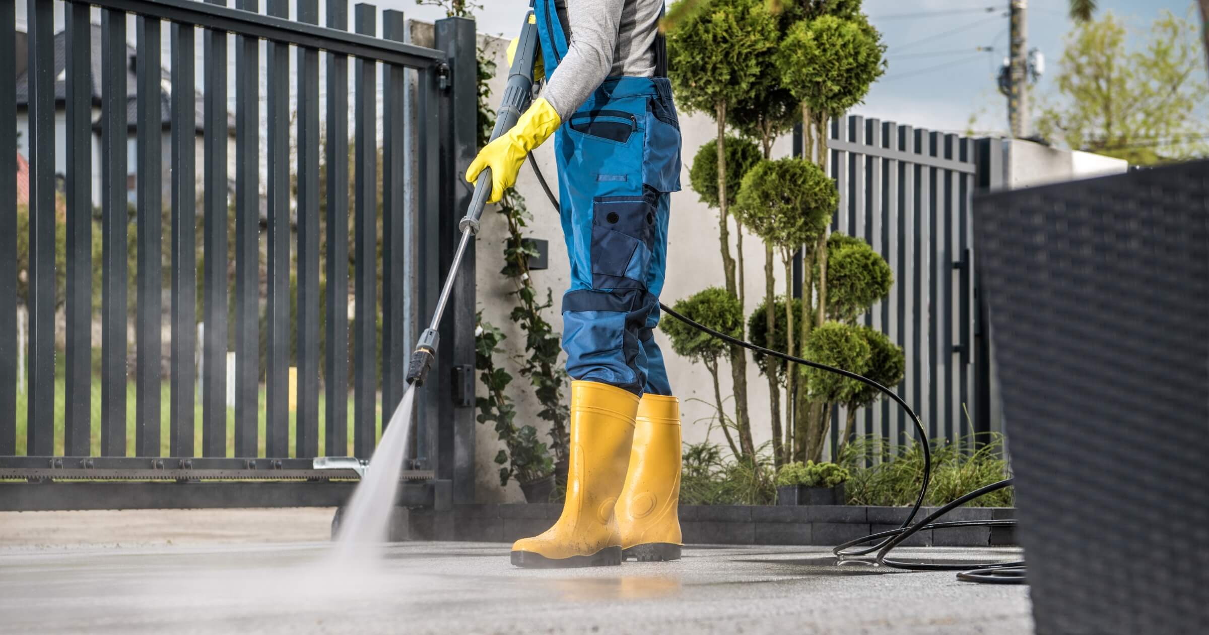 worker using battery-powered pressure washer