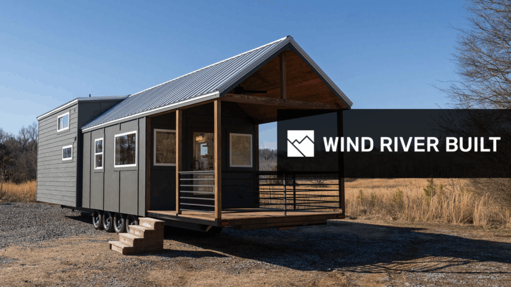 Wind River Built with small dark tiny home with front porch