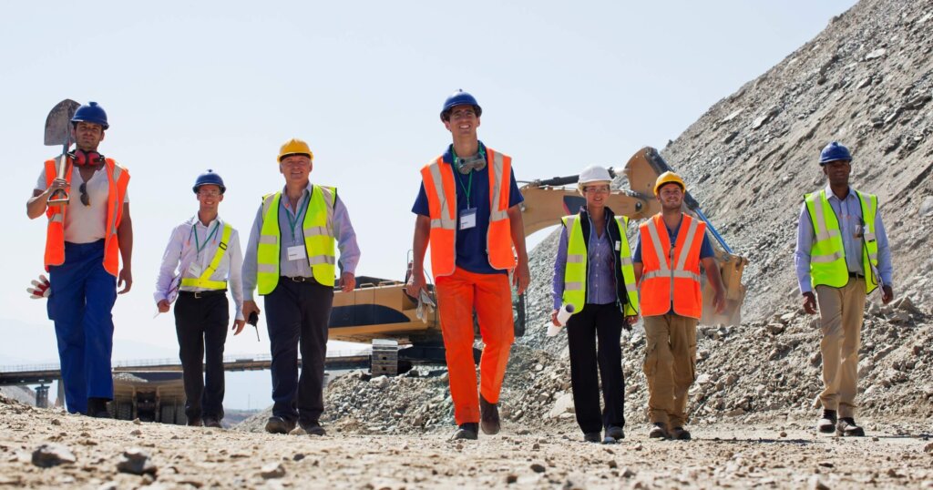 Workers walking in a remote quarry jobsite.
