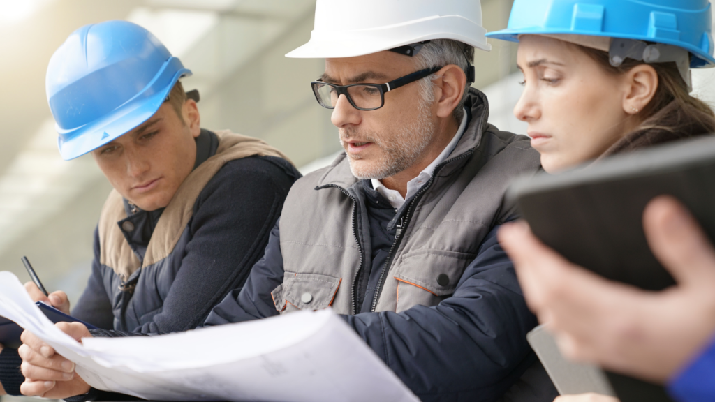 Top engineering apprenticeship programs across the U.S. 1 Engineer with apprentices looking at drawings