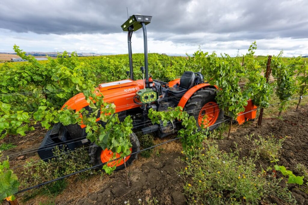 Kubota M5 autonomous tractor with tracker equipped with Ai sensors on a farm.