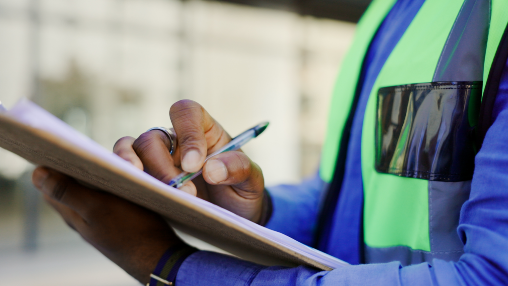 Construction estimator writing on clipboard
