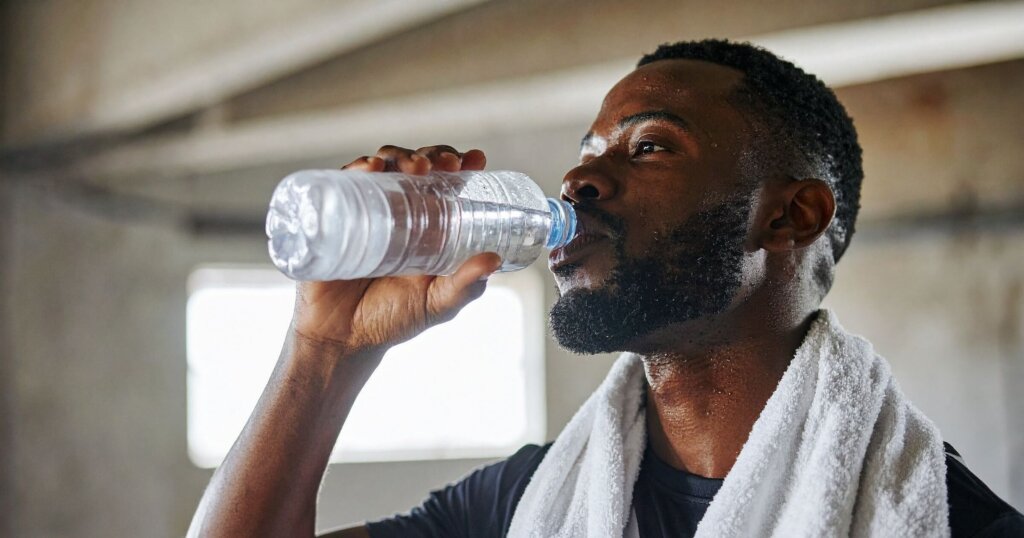 How to reduce the effects of caffeine 1 Man drinking water to reduce the effects of caffeine