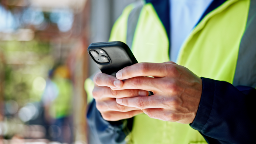 Construction worker using mobile phone