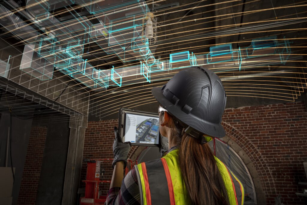Female construction worker using Autodesk Forma with overlay