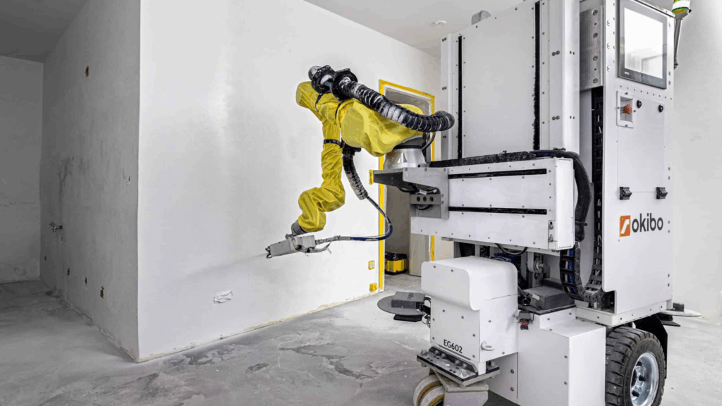 Okibo BLASTER paint gun attached to EG7+ robot spraying wall
