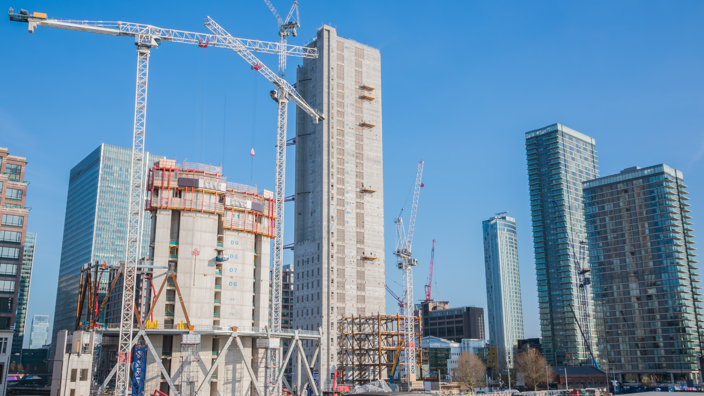 A modern urban construction site with high-rise buildings and cranes