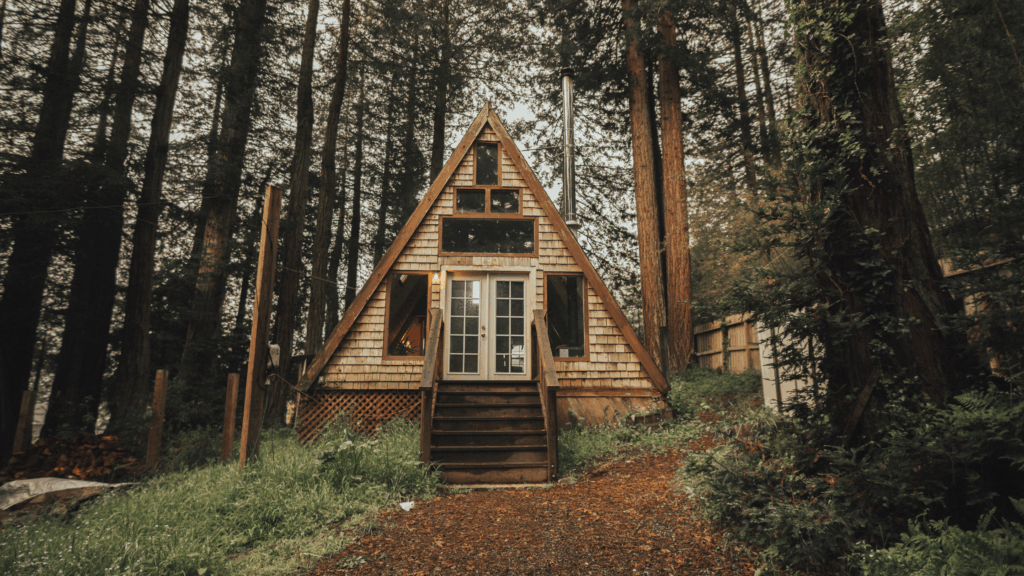 How much does it cost to build a cabin? 1 A-frame wood cabin in the forest