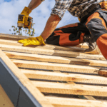 Skilled trades person working on roof of a house