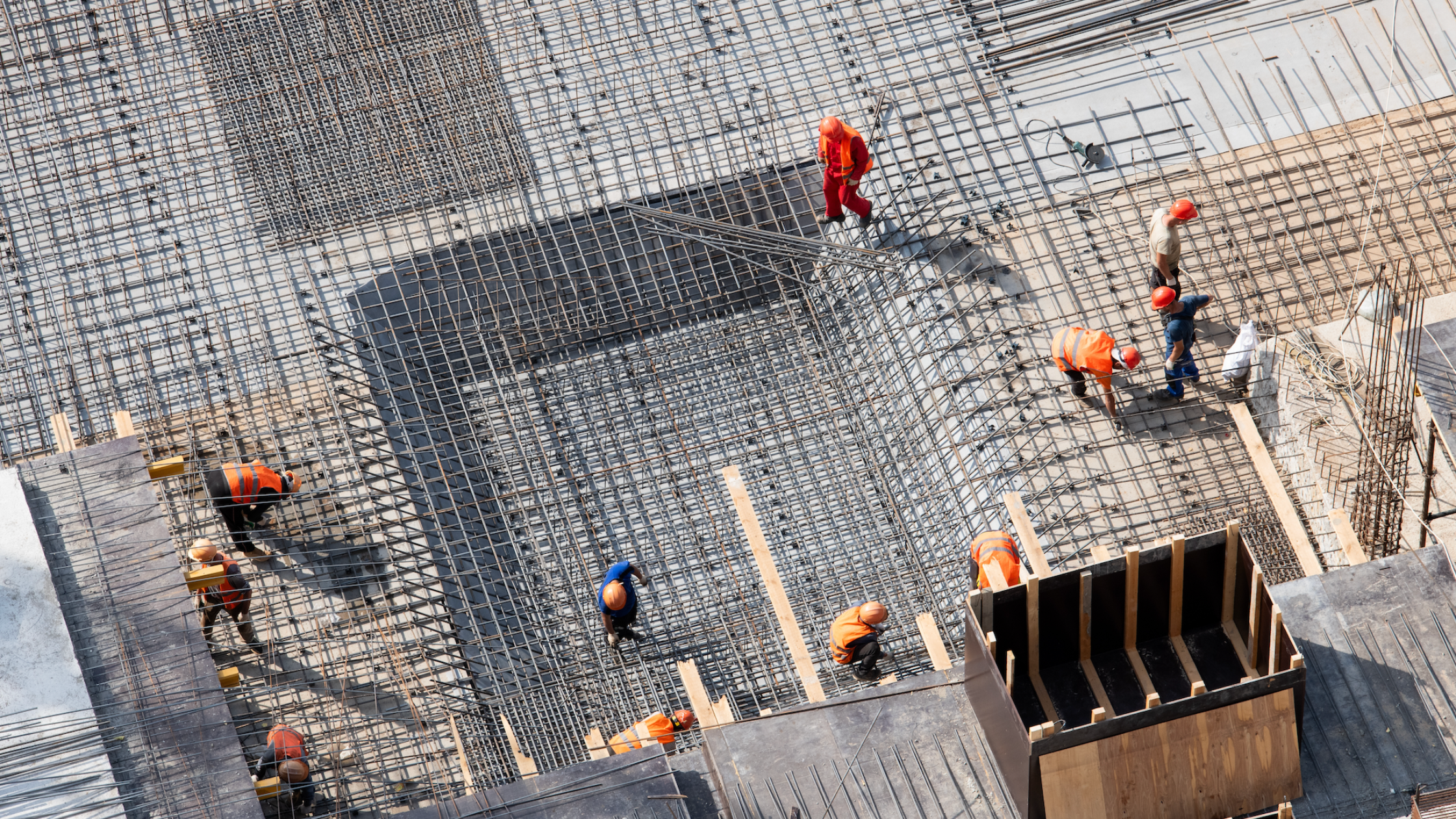 Construction crew laying steel rebar