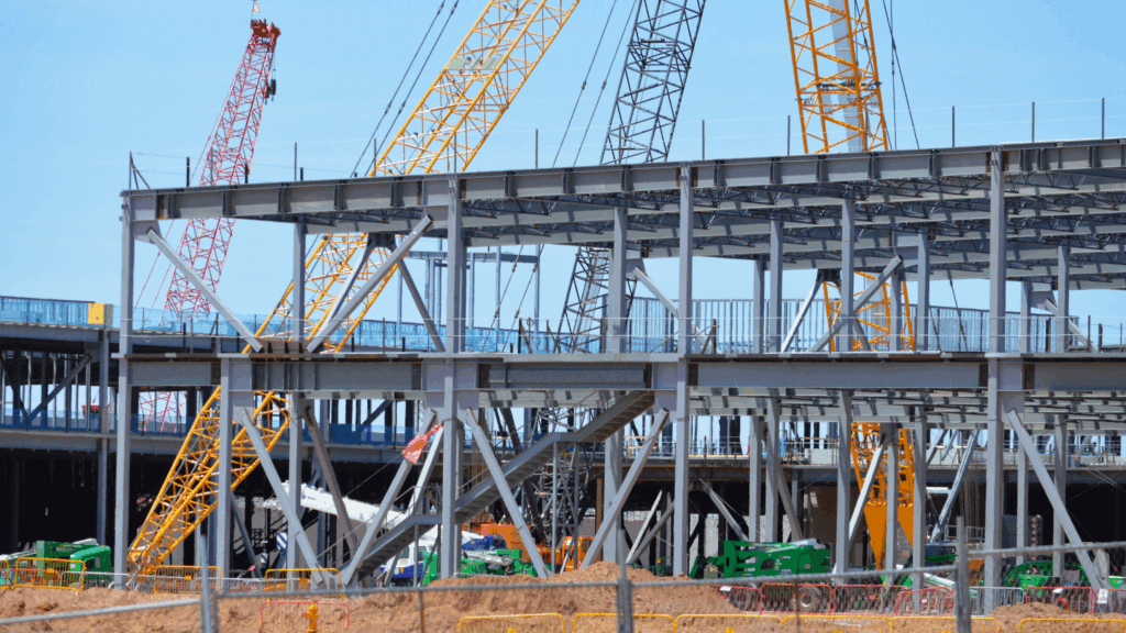 Steel-frame data center construction jobsite with multiple cranes, typical of Meta infrastructure where ABC academy graduates will work