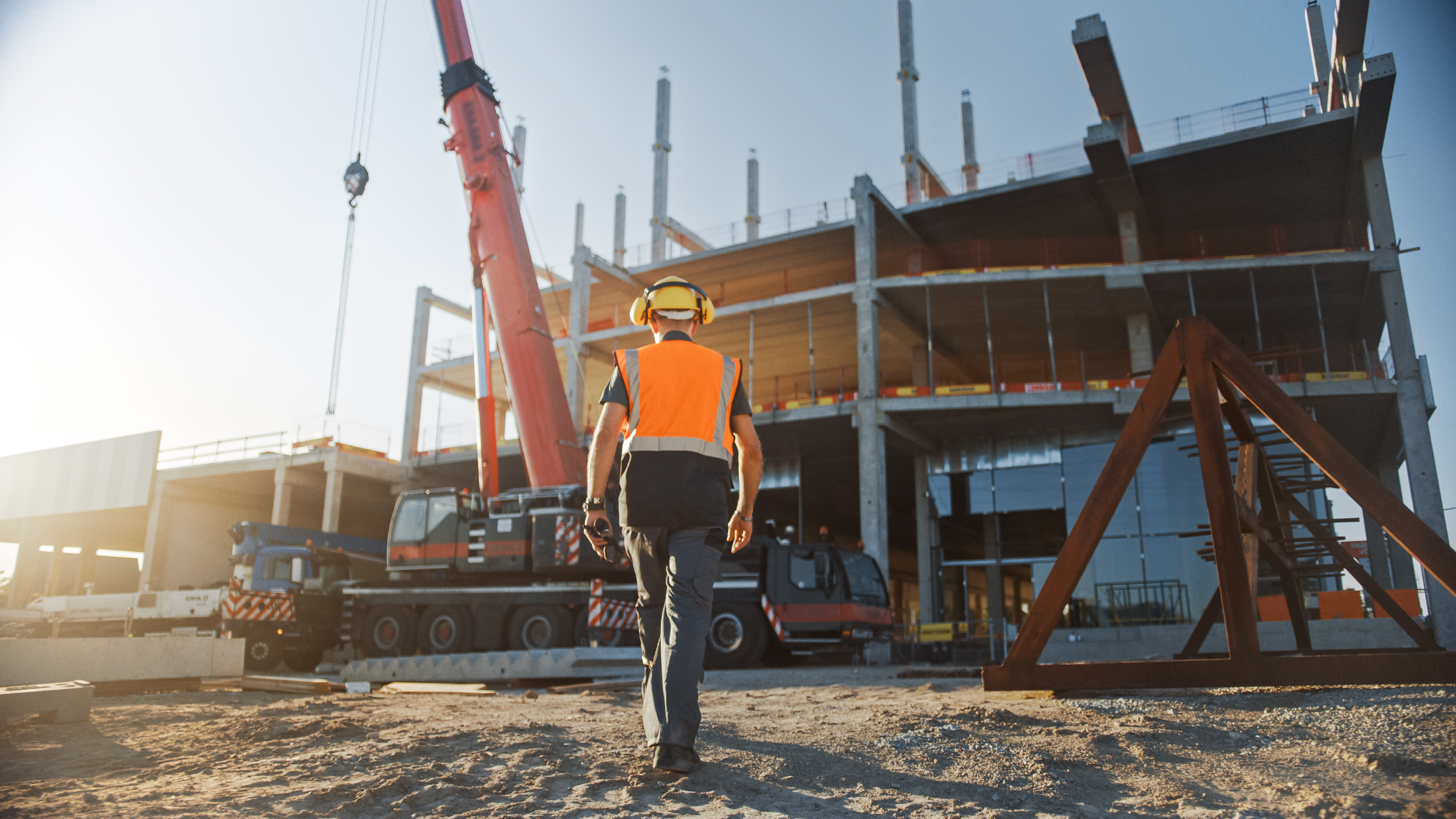 Worker walking onto residential construction site